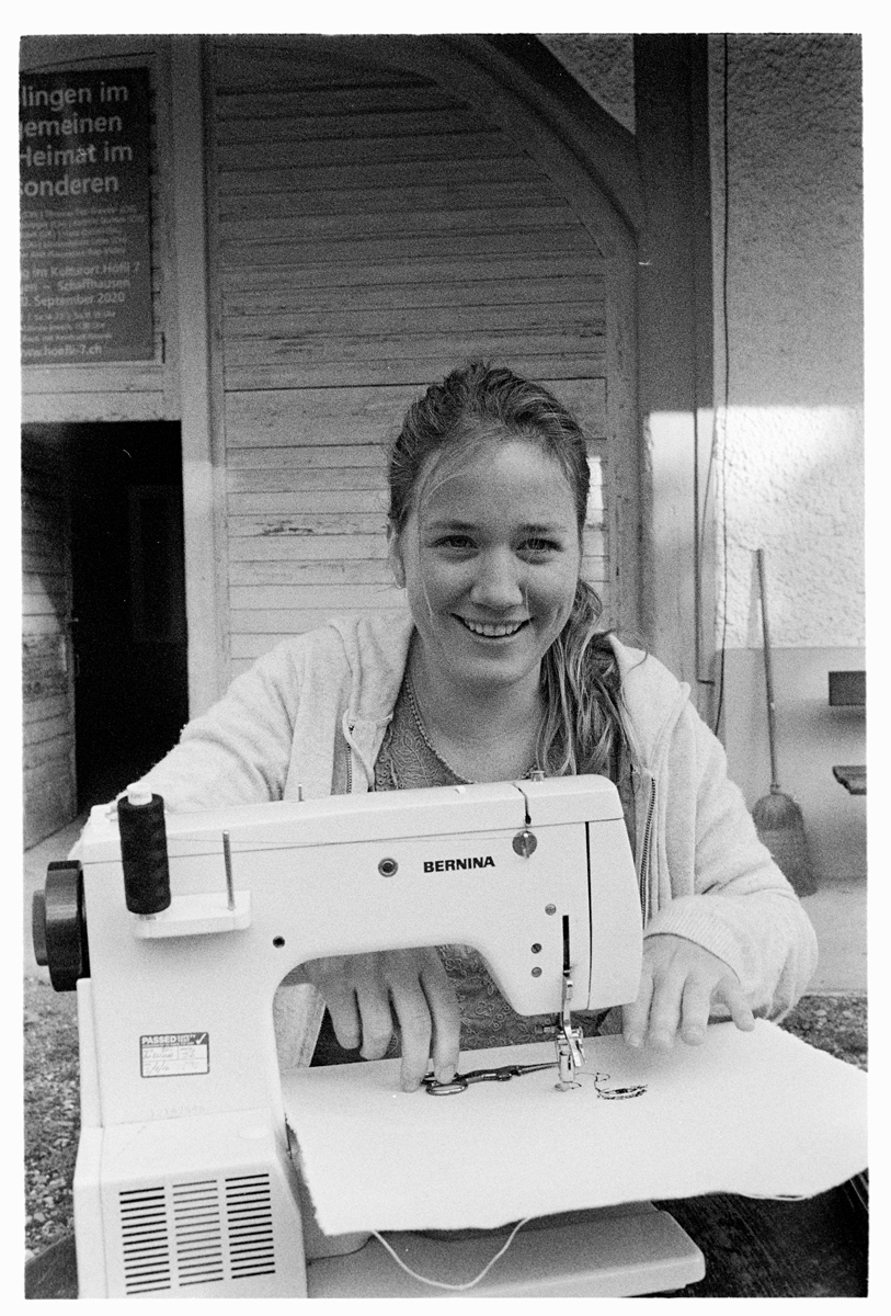Artist Harriet Riddell. A black and white photograph of a woman sitting at a sewing machine.