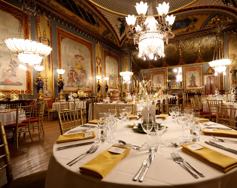 Dragon Banquet in the Royal Pavilion. Round tables are set for dinning in the Banqueting Room.
