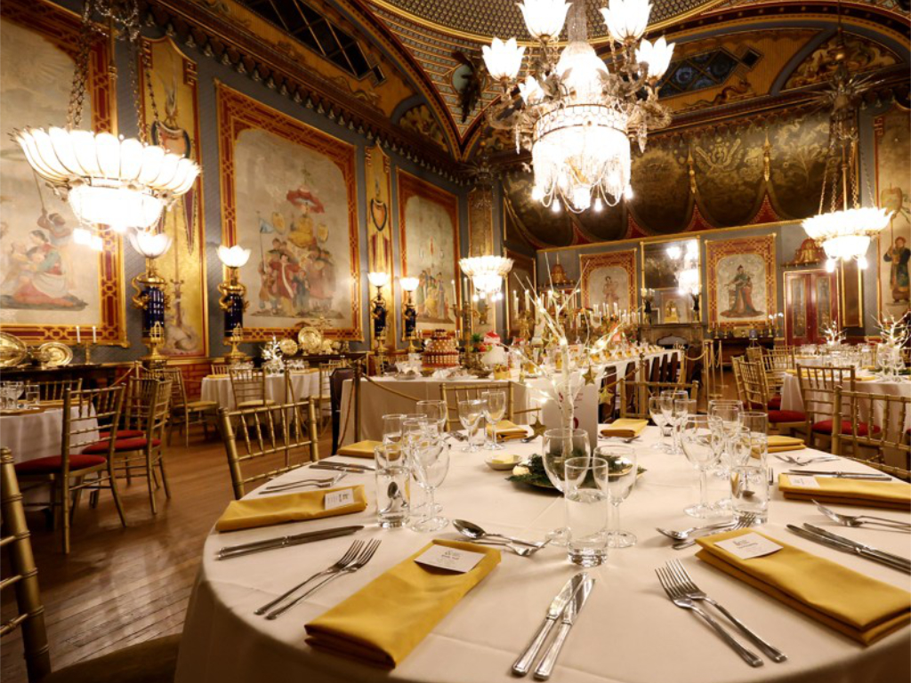 Dragon Banquet in the Royal Pavilion. Round tables are set for dinning in the Banqueting Room.